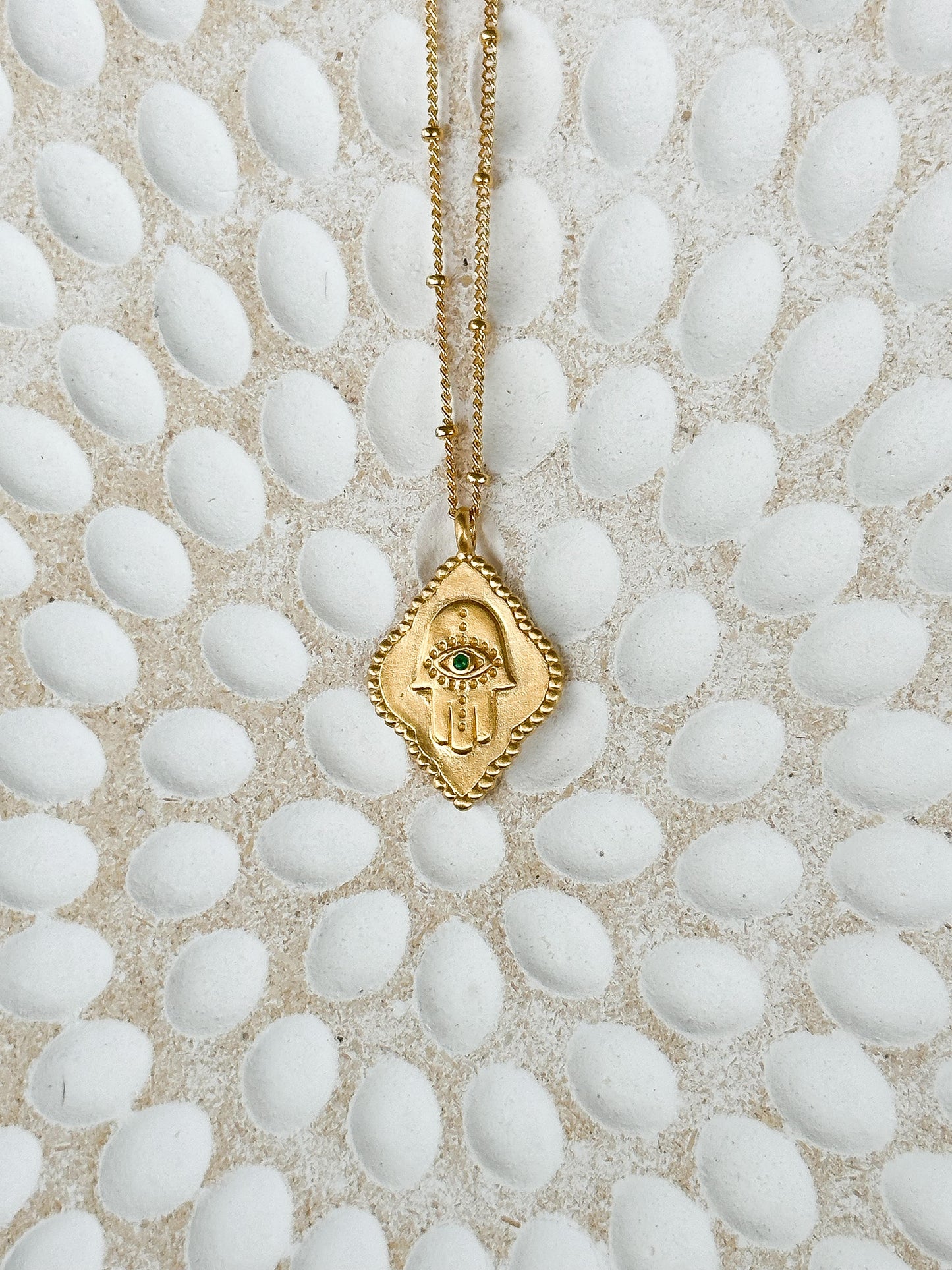 Cradled in Protection Gold and Emerald Hamsa Amulet Necklace