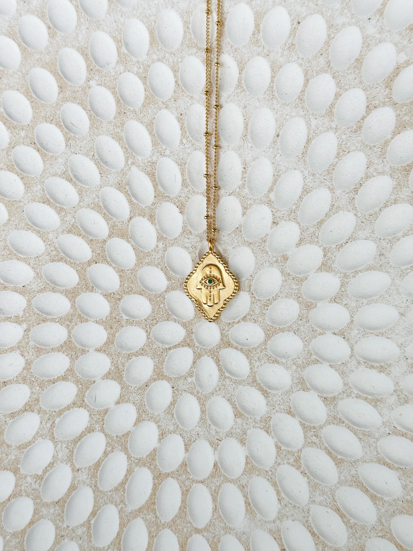 Cradled in Protection Gold and Emerald Hamsa Amulet Necklace
