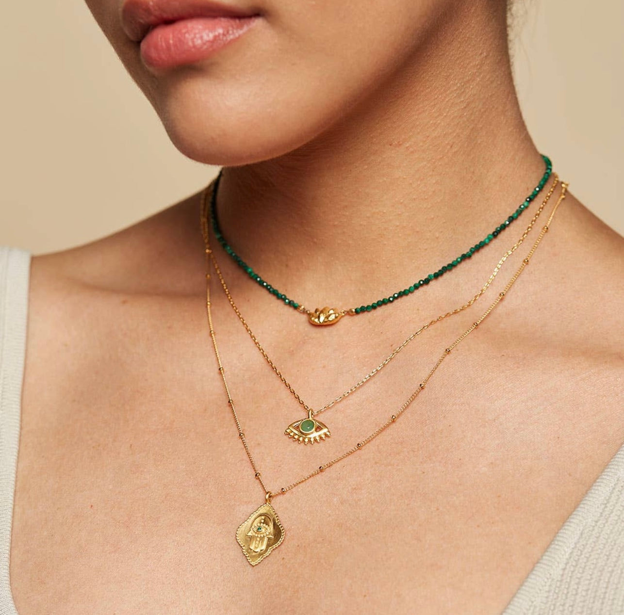 Cradled in Protection Gold and Emerald Hamsa Amulet Necklace
