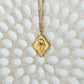 Cradled in Protection Gold and Emerald Hamsa Amulet Necklace
