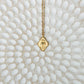 Cradled in Protection Gold and Emerald Hamsa Amulet Necklace