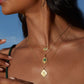 Cradled in Protection Gold and Emerald Hamsa Amulet Necklace