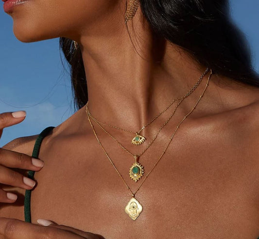 Cradled in Protection Gold and Emerald Hamsa Amulet Necklace