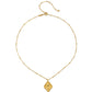 Cradled in Protection Gold and Emerald Hamsa Amulet Necklace